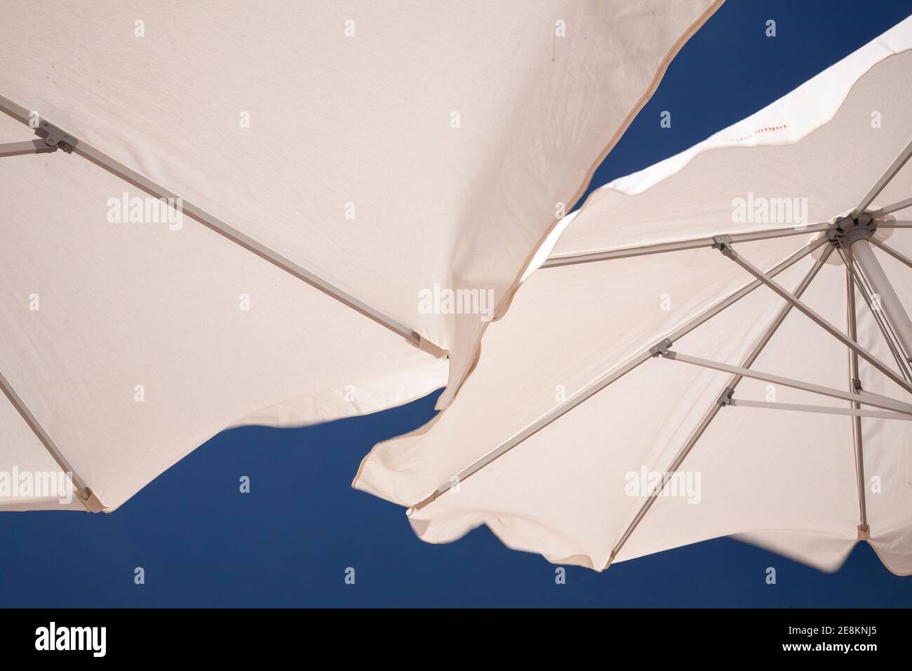 White parasols on the beach at Cadiz, Spain Stock Photo