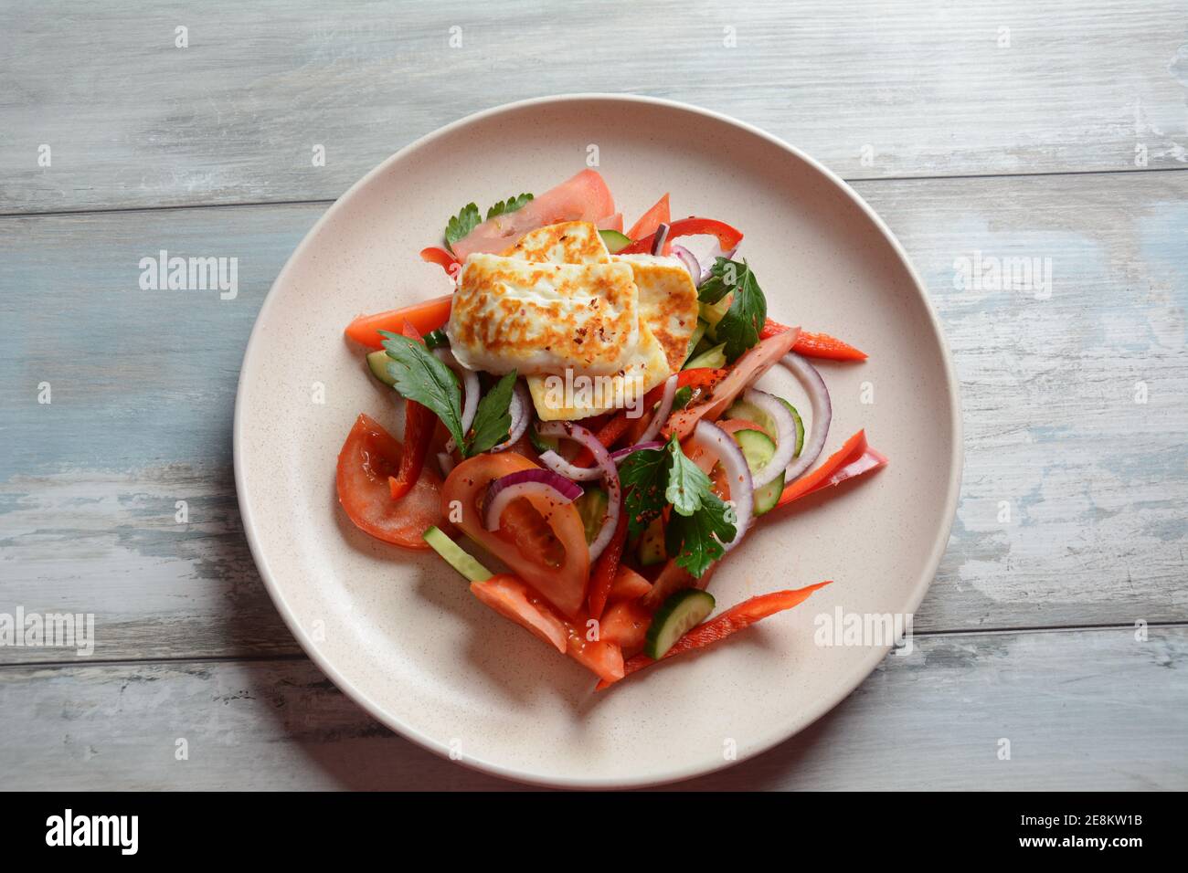 Grilled Halloumi Cheese salad with tomatoes, cucumbers, red pepper, red