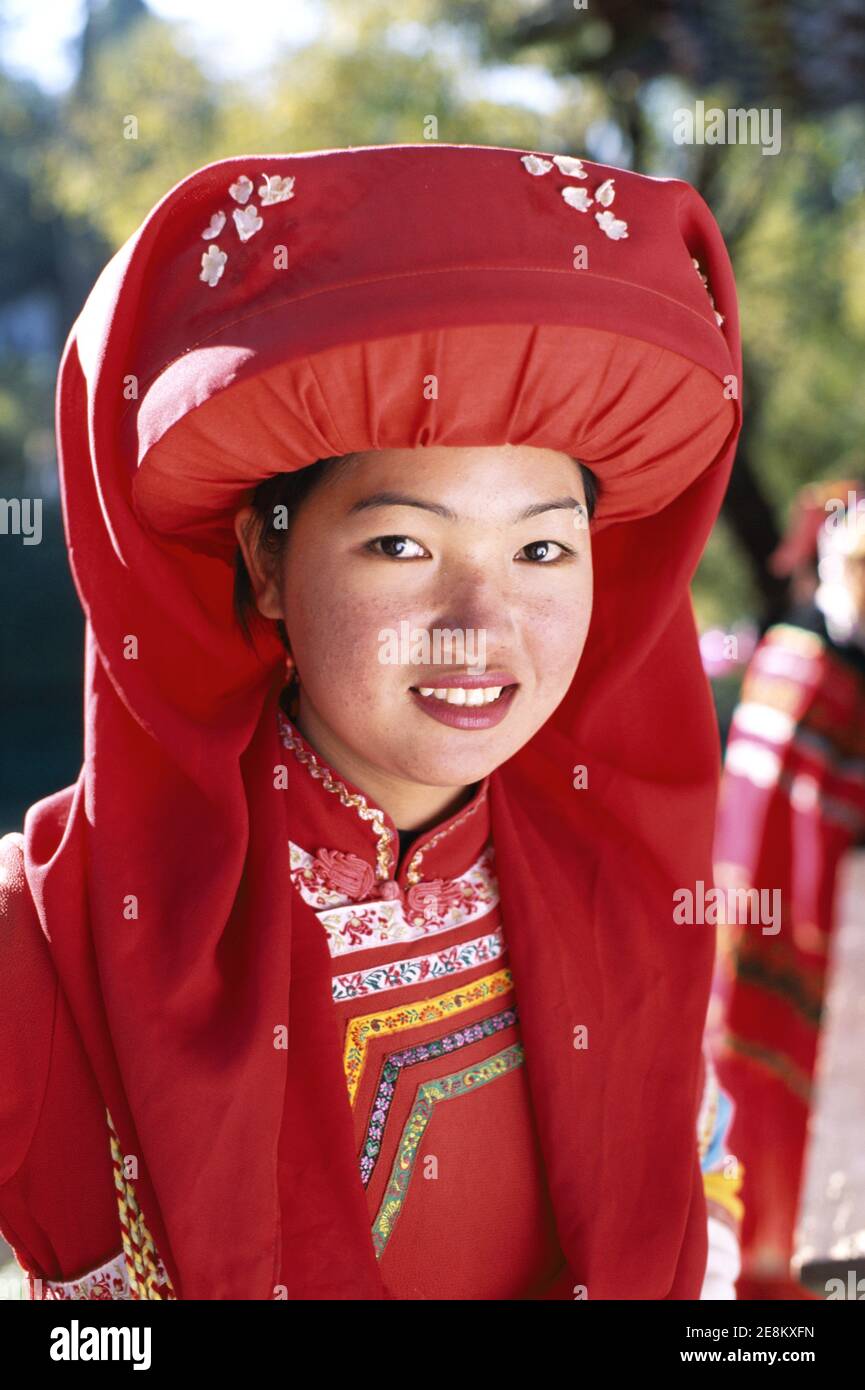 Asia,China,Yunnan, Lijiang, Lisu ethnic Minority Girl wearing  traditional colourful red Lisu Hilltribe Costume Stock Photo
