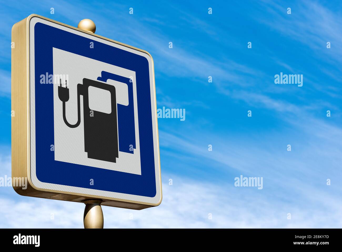 Closeup of a modern road sign for an Electric Vehicle Charging Station on blue sky with clouds. Photography. Stock Photo