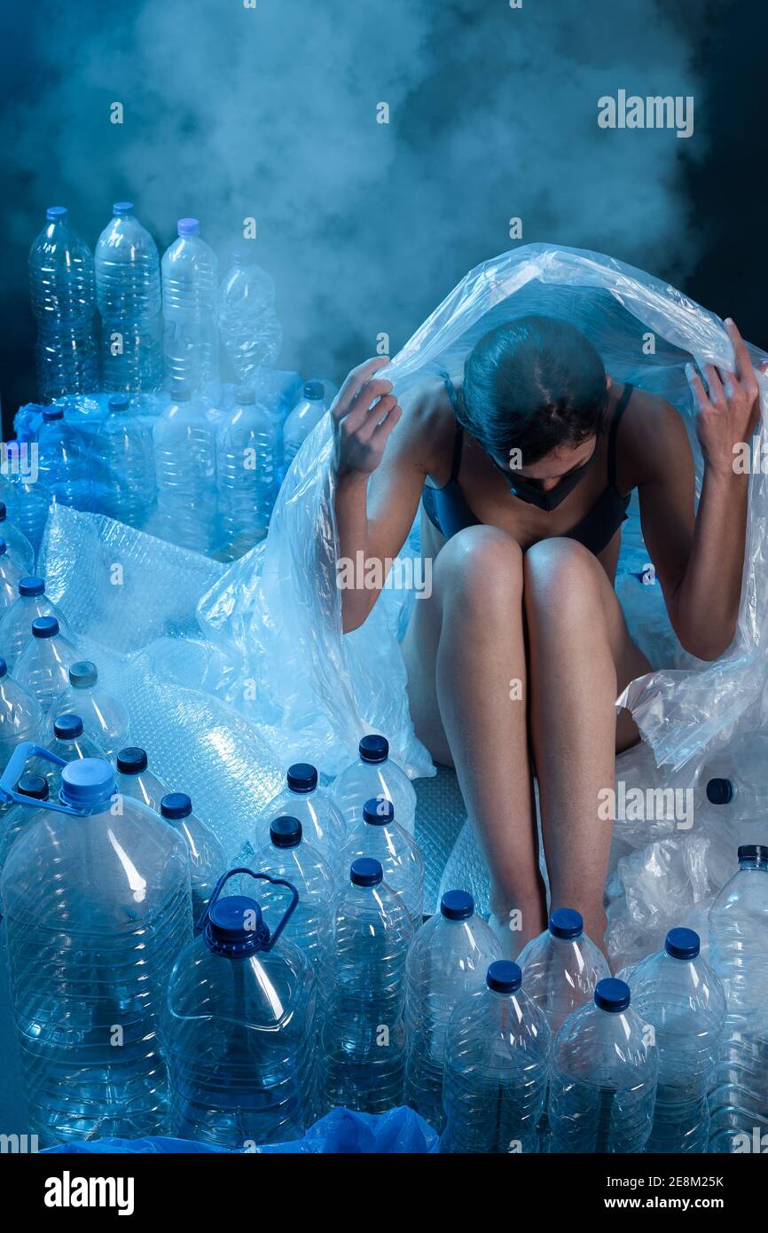 Woman protecting herself from plastic pollution. Concept of Recycling plastic and ecology. Stock Photo