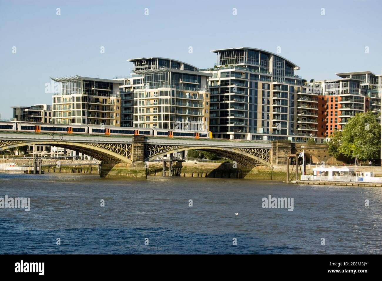 A London Transport overground train travelling over the Cremorne Railway Bridge over the River Thames at Chelsea. Stock Photo