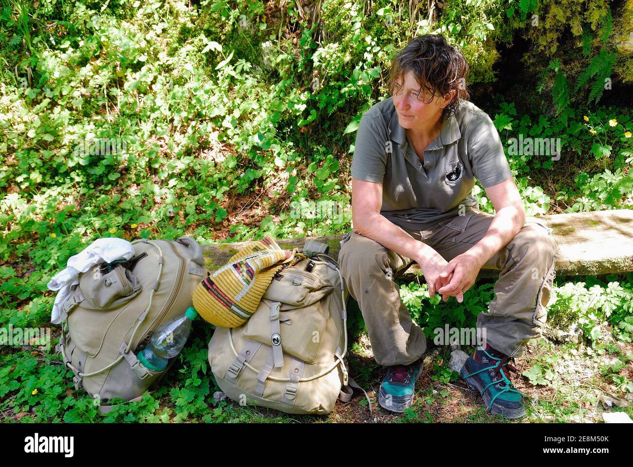 mount Krn, Slovenia.A tired woman rests after a day of trekking. Stock Photo