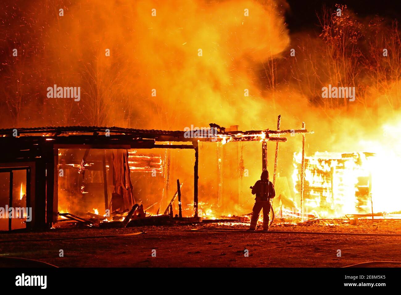 Firemen at a fire scene Stock Photo - Alamy