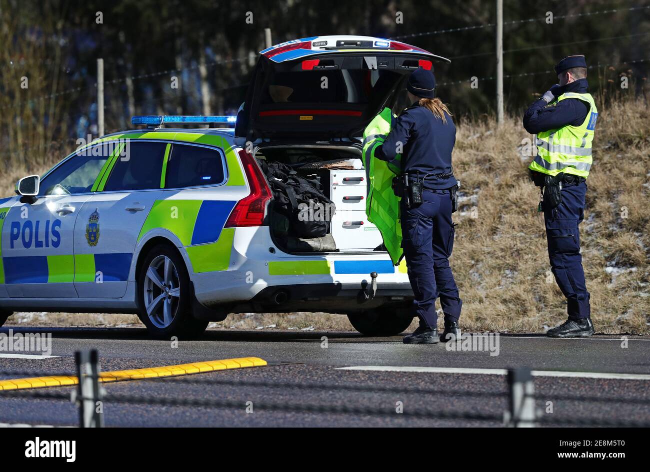 Motala, Sweden 20200403Police officers at a police car. Stock Photo