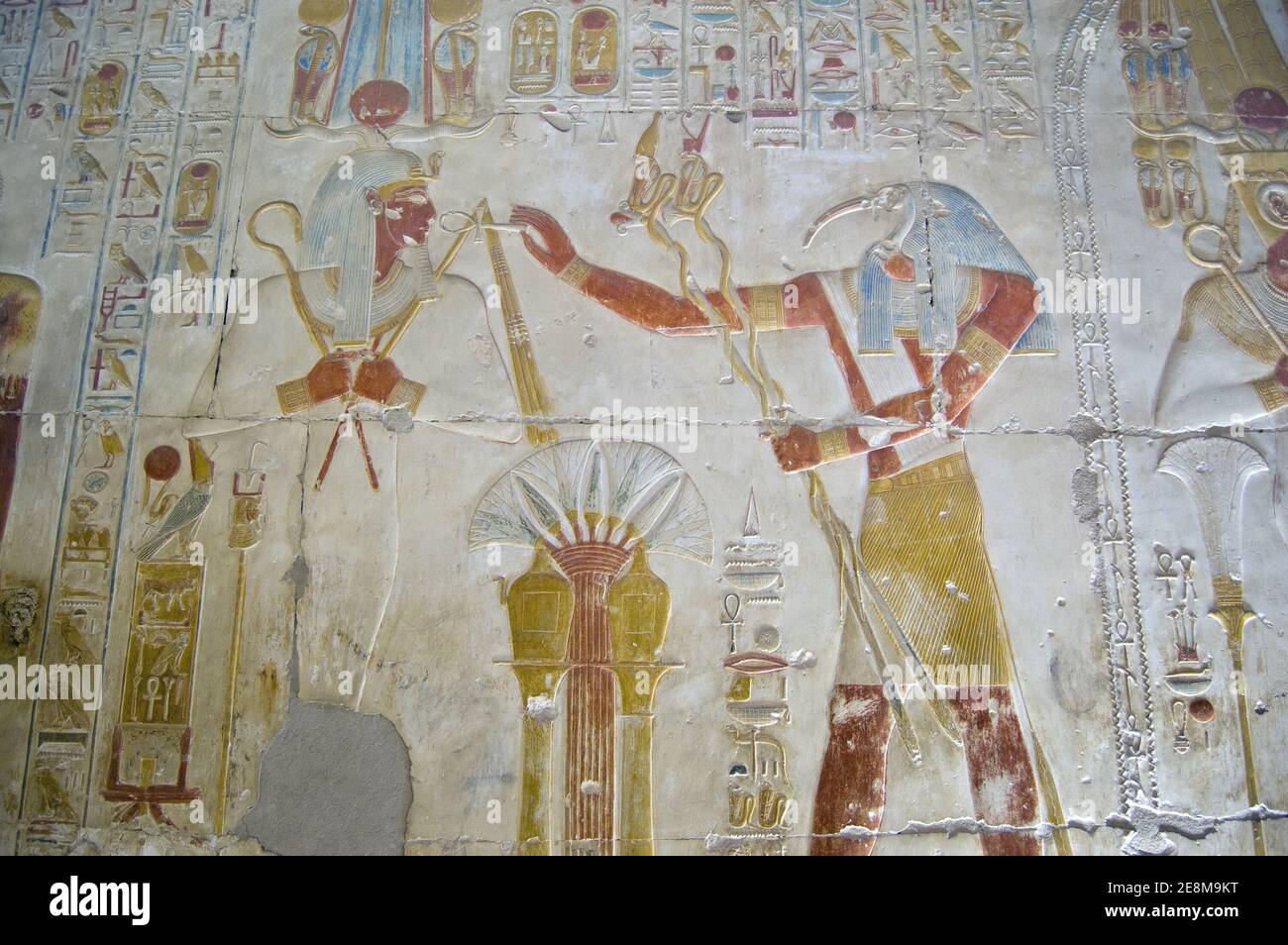 Ancient Egyptian bas relief showing the Ibis headed god Thoth praising god of the dead Osiris. Wall at Abydos Temple, el Balyana, Egypt. Ancient carvi Stock Photo