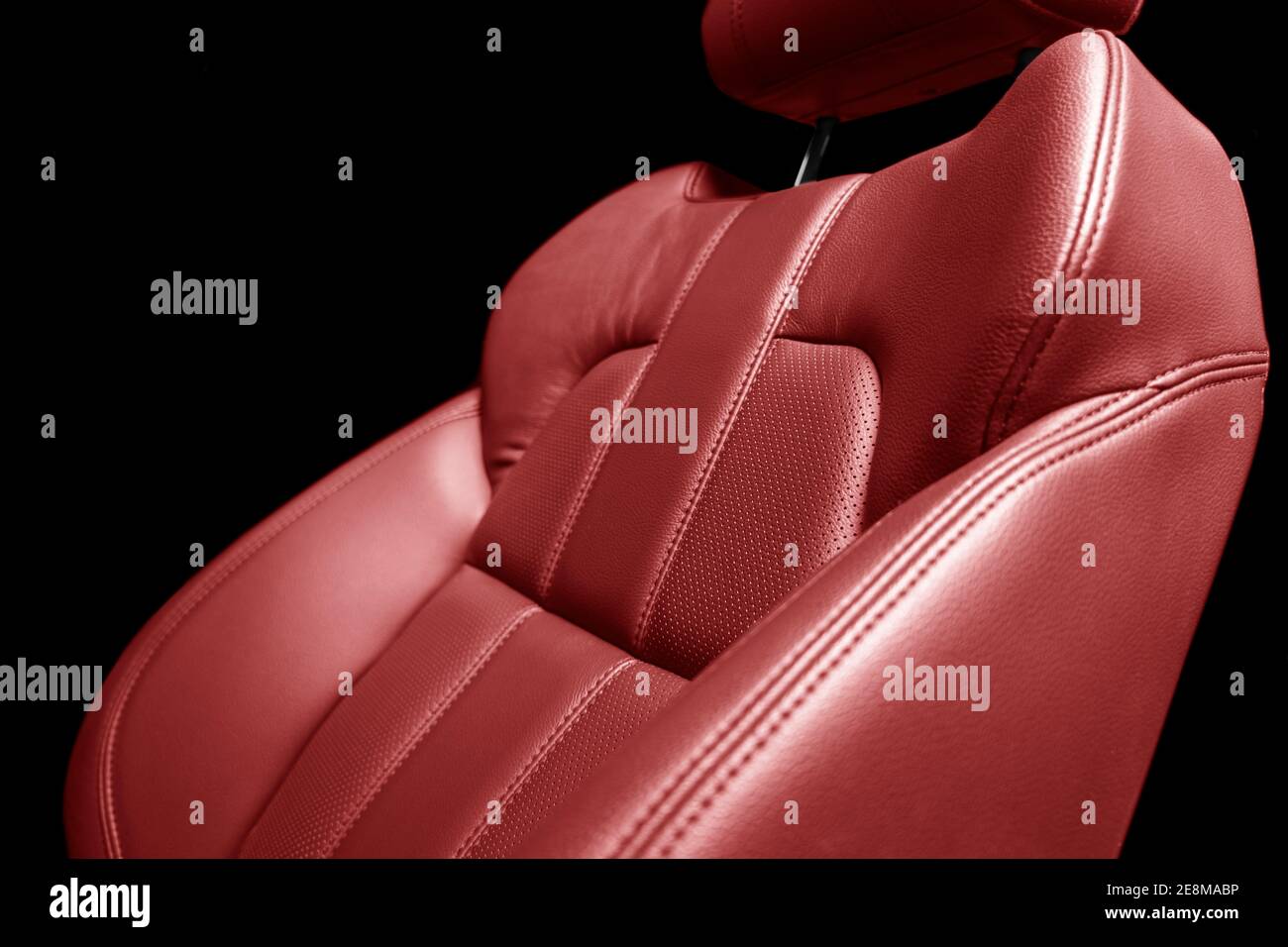 Modern luxury car red leather interior. Part of red perforated leather