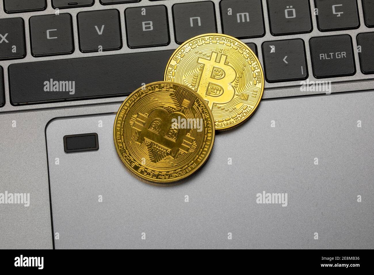 Bitcoin gold coin. Cryptocurrency and laptop Stock Photo