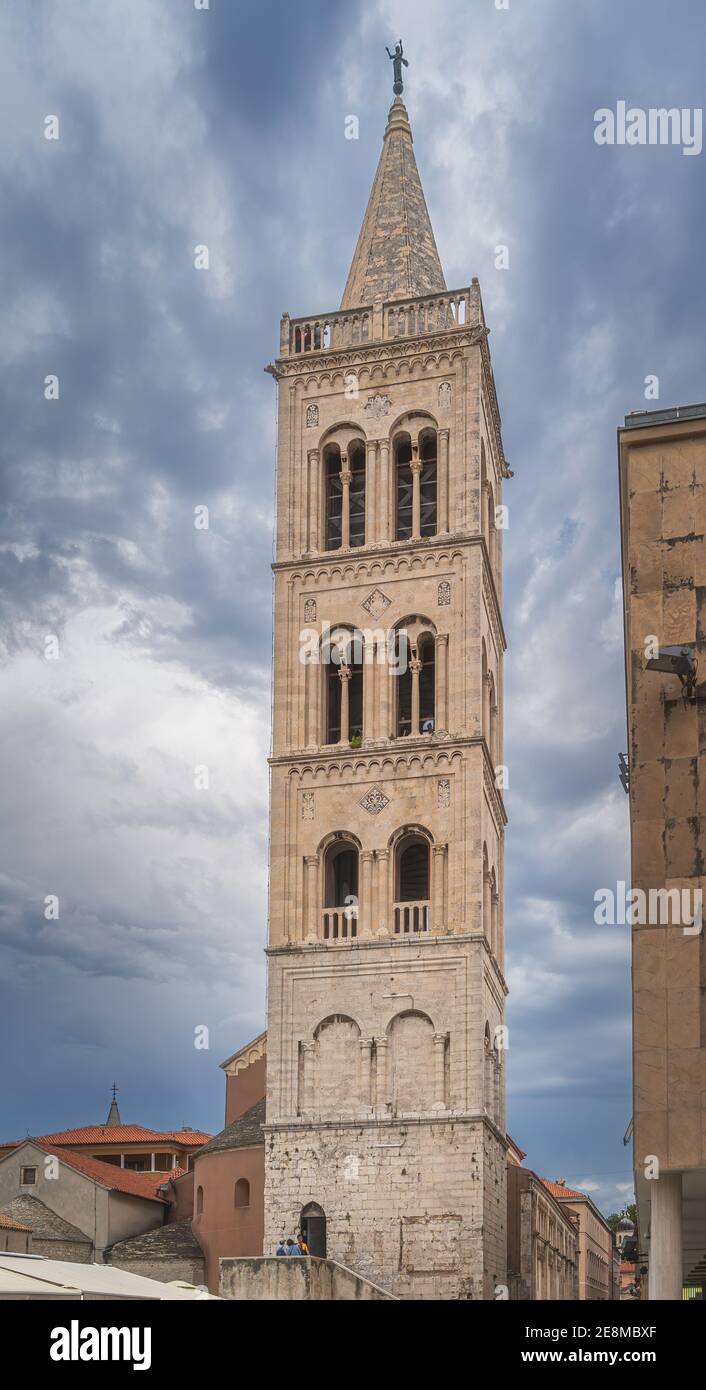 Tall bell tower of a St. Donata Church in early Romanesque architecture in Zadar old town, Croatia. Dramatic, stormy sky Stock Photo