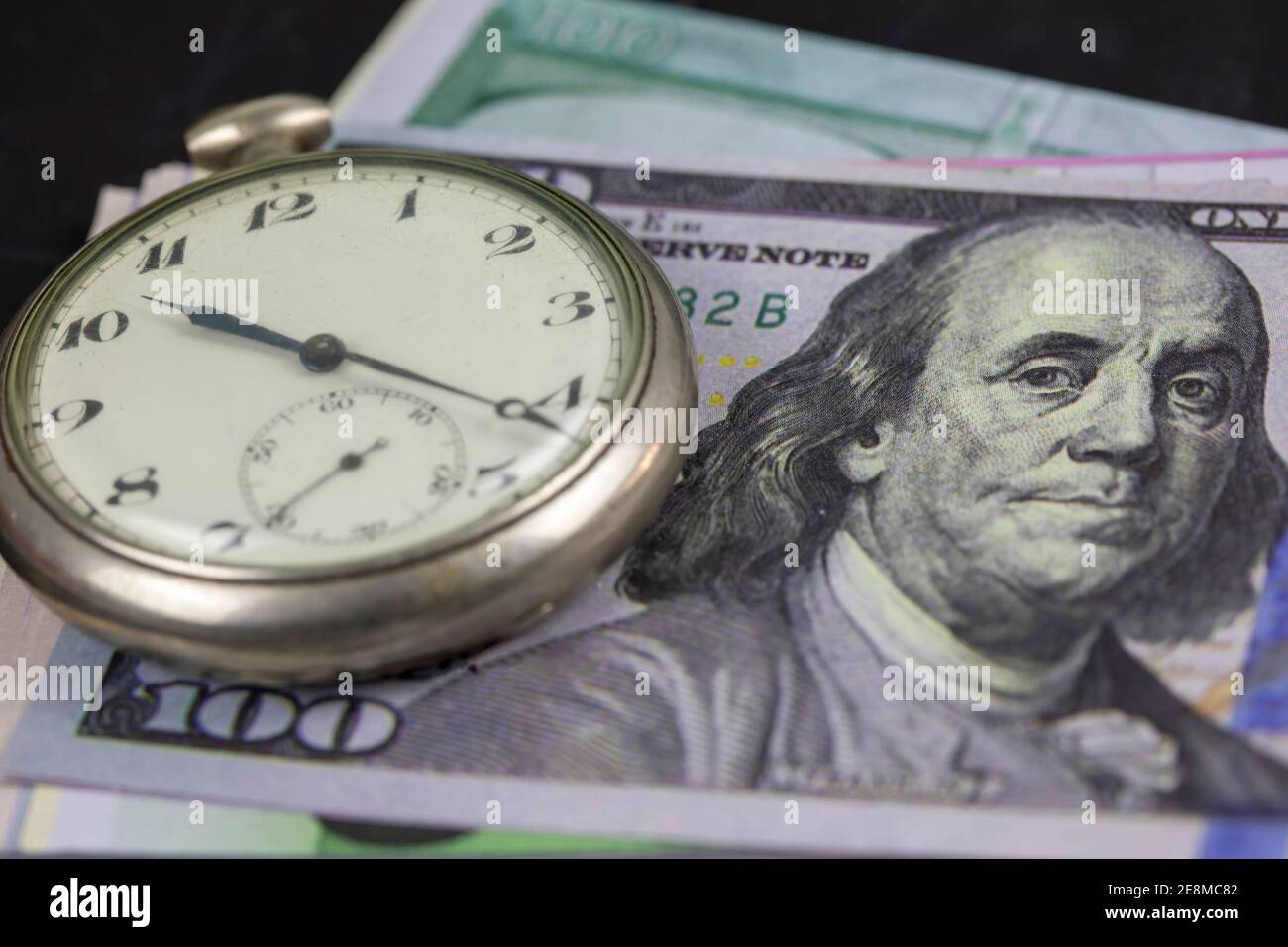 Time is money. Pocket Watch and money Stock Photo - Alamy