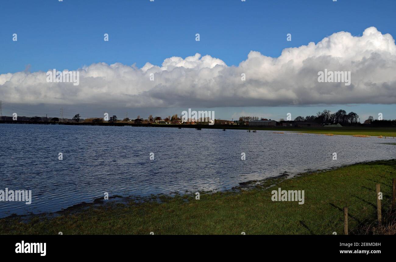 On the West Lancashire plain agricultural fields off Mains Lane, Burscough have become flooded in the winter rains, now gone to reveal blue skies. Stock Photo