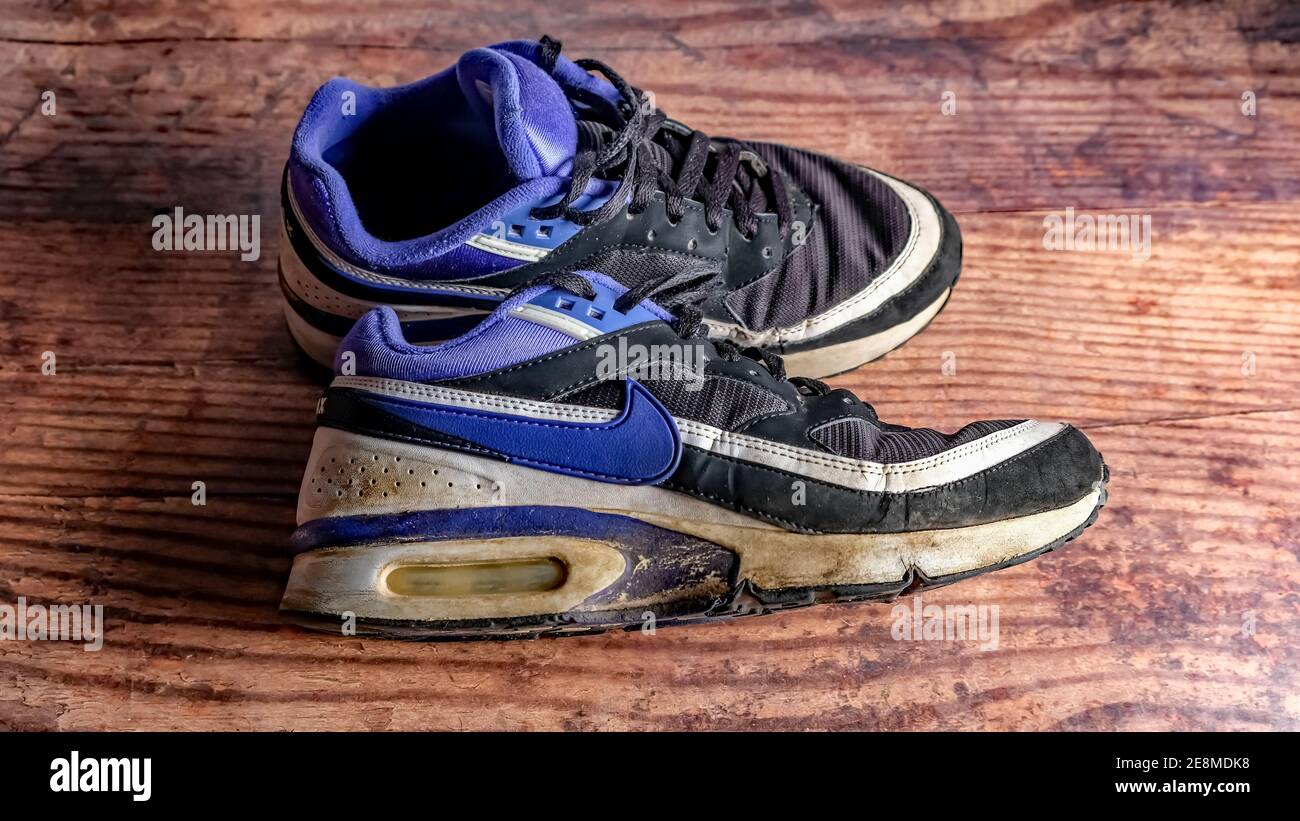 Norwich, Norfolk, UK – December 19 2020. An illustrative photo of a pair of old and well worn retro Nike Air Max Classic trainers in black and purple Stock Photo Alamy