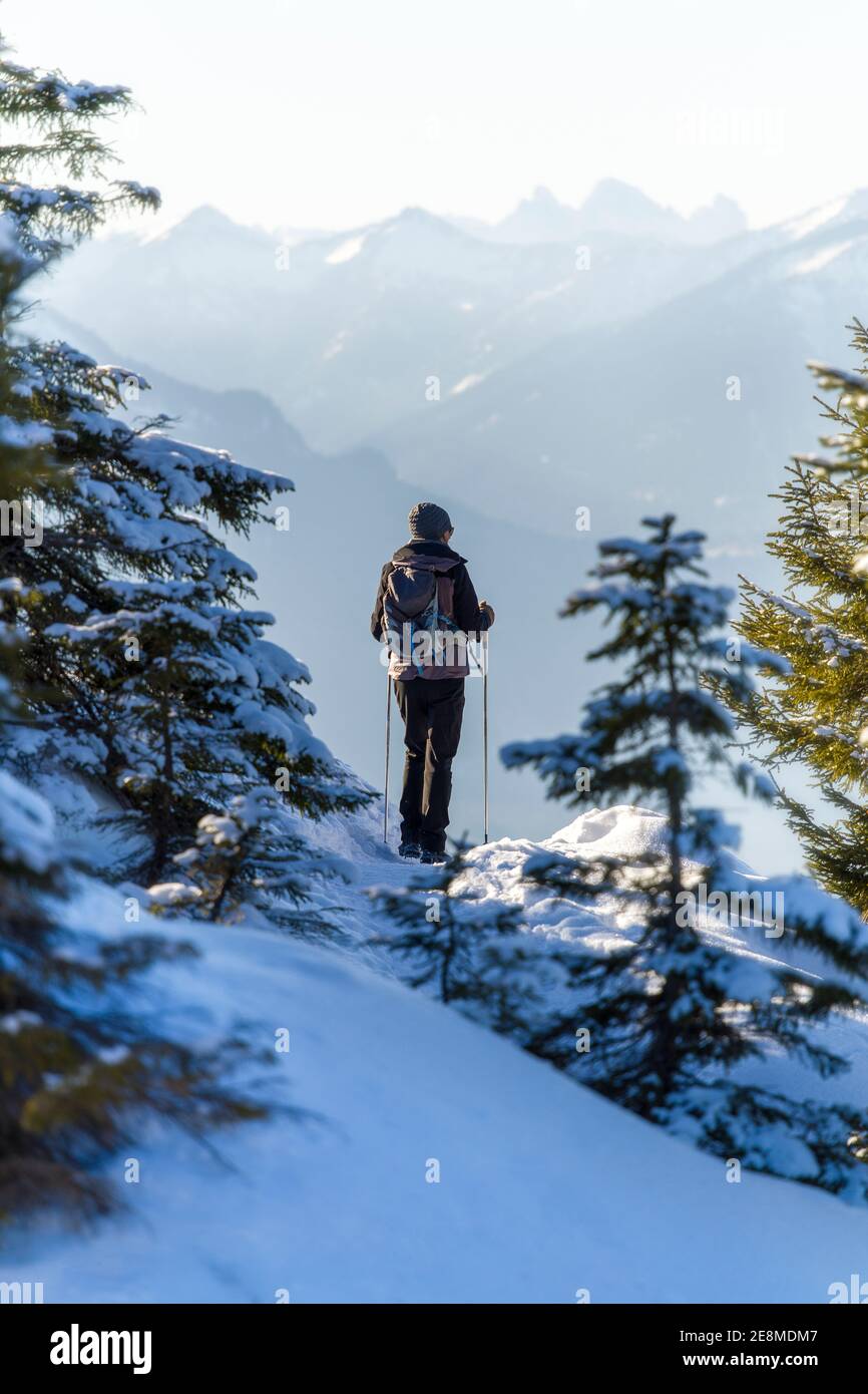 female hiker in beautiful snow covered mountains Stock Photo