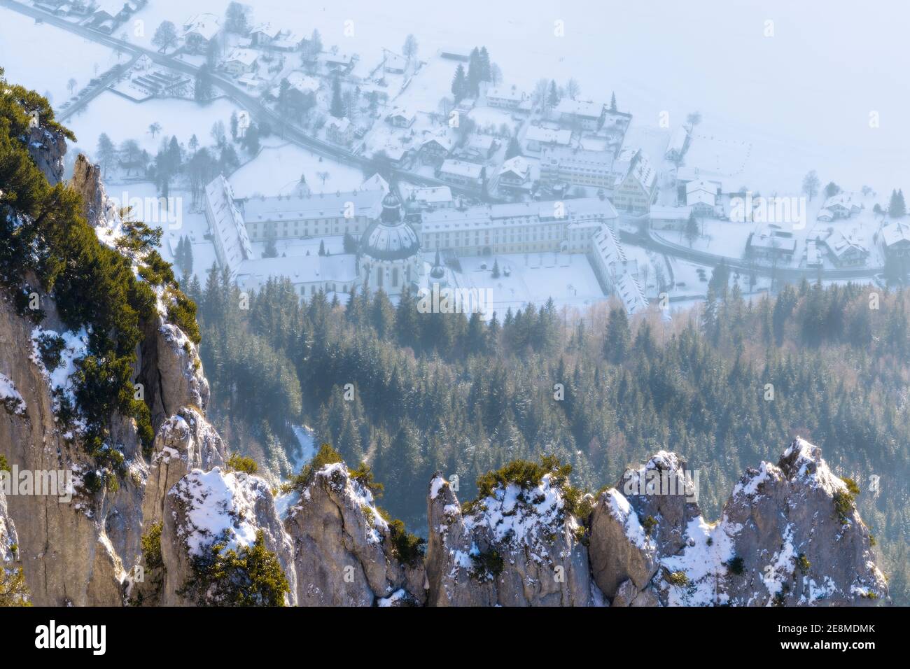Beautifully sun lit mountains covered in snow with Ettal abbey in background Stock Photo