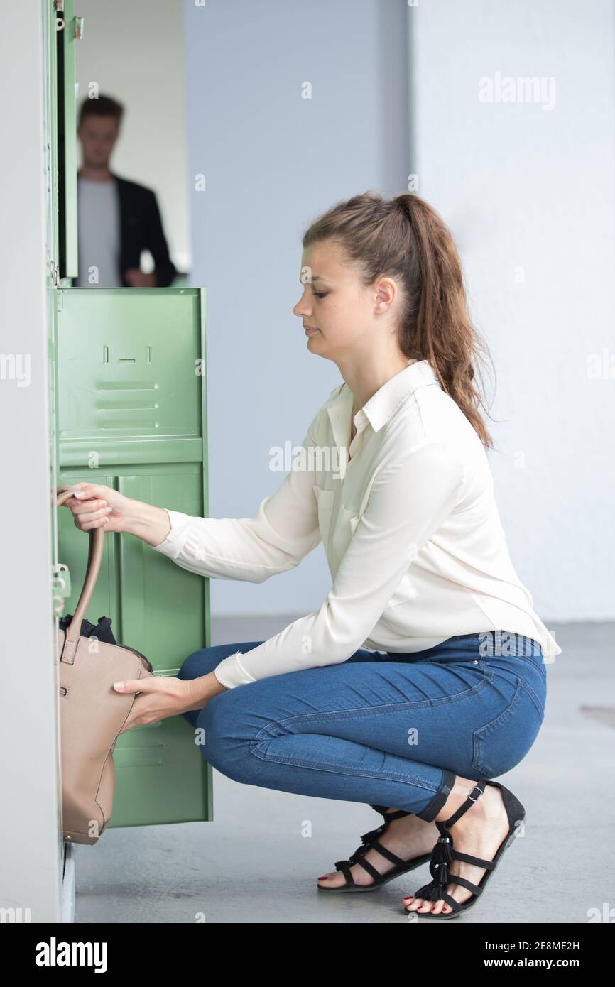 she is putting bag in locker Stock Photo Alamy