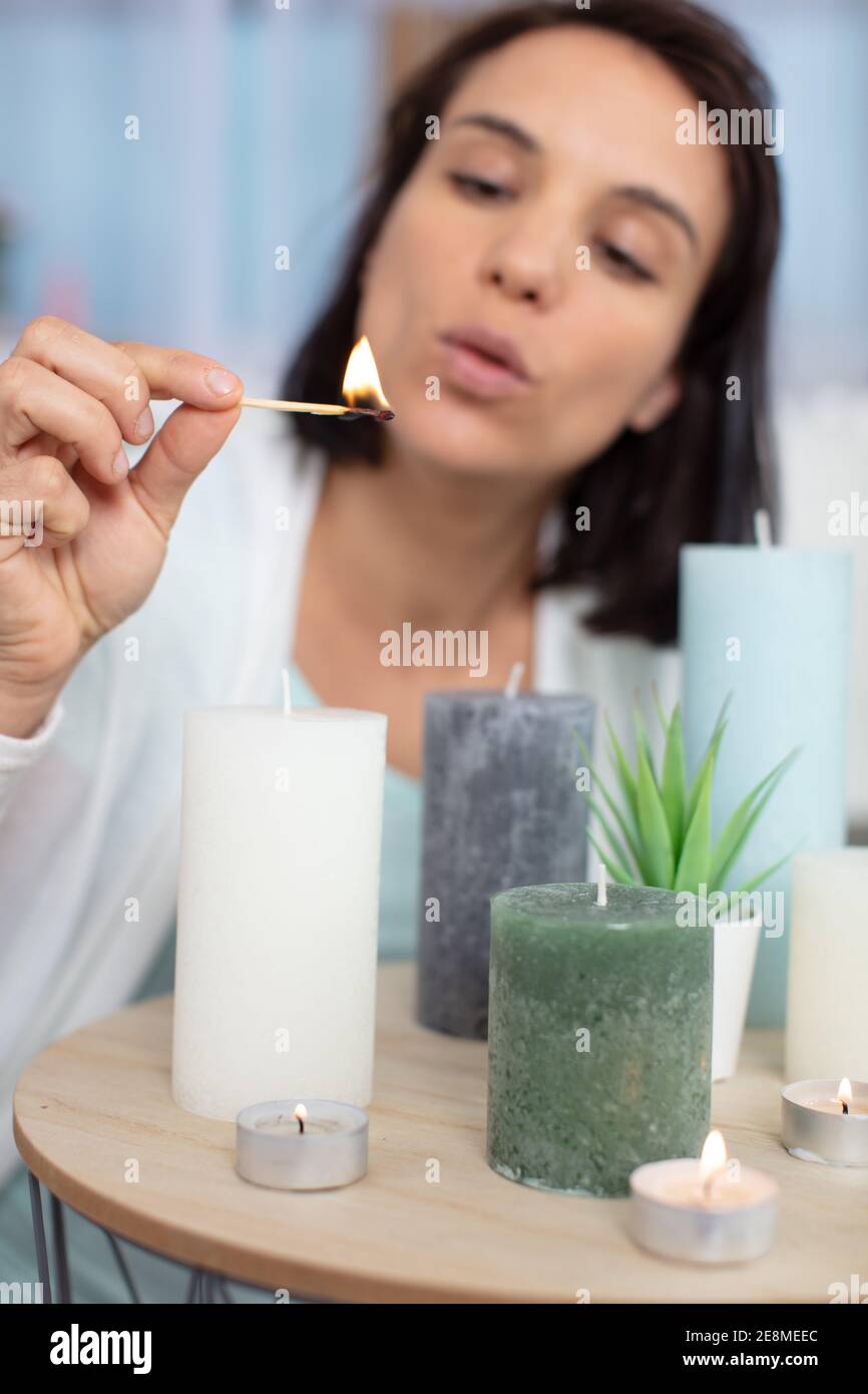 woman lighting candles with a match Stock Photo Alamy