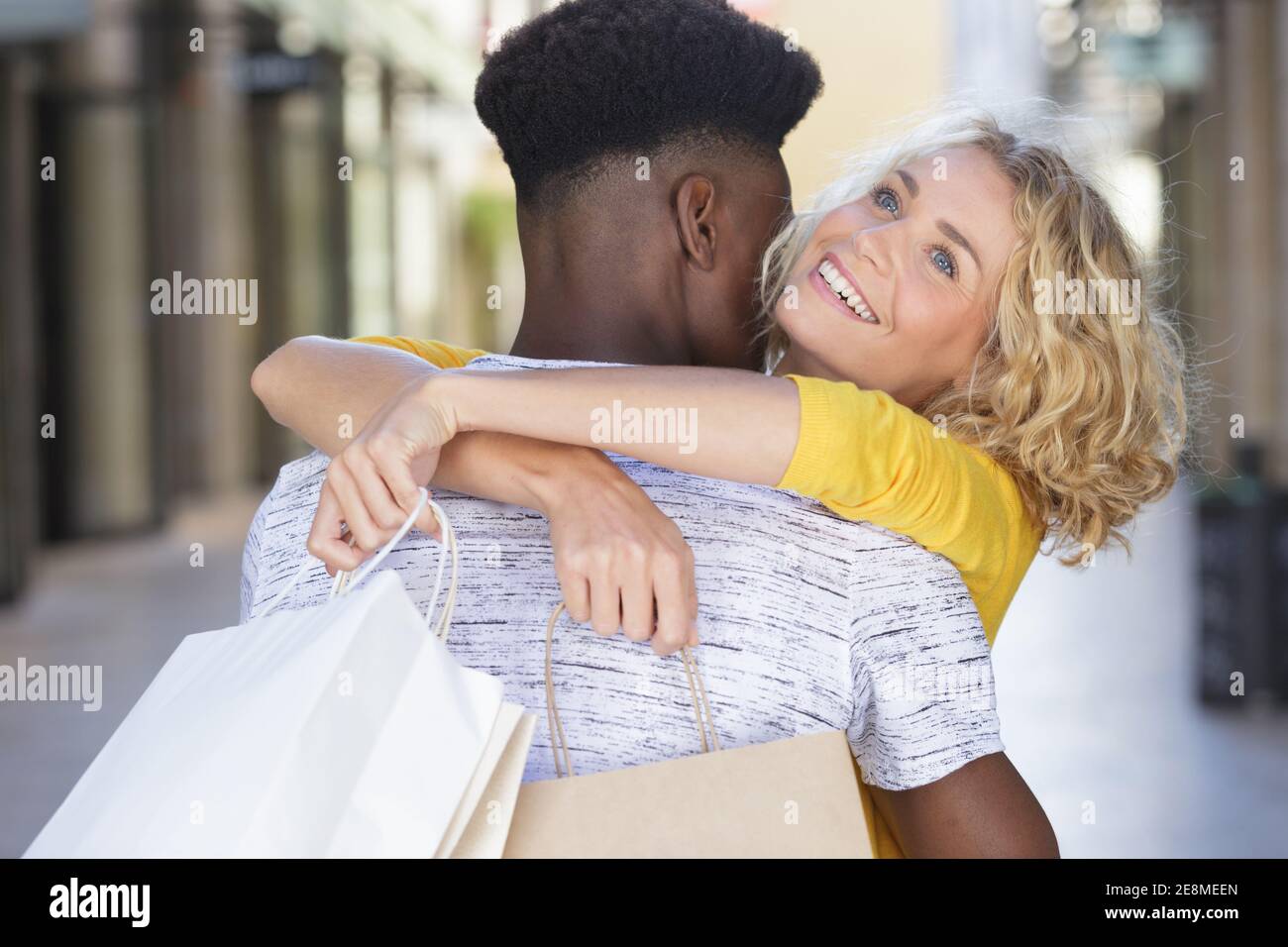 happy beautiful young couple hugging and smiling Stock Photo - Alamy