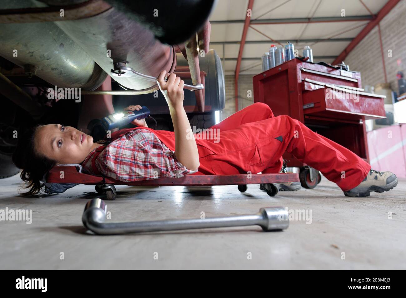 female mechanic underneath a car Stock Photo Alamy