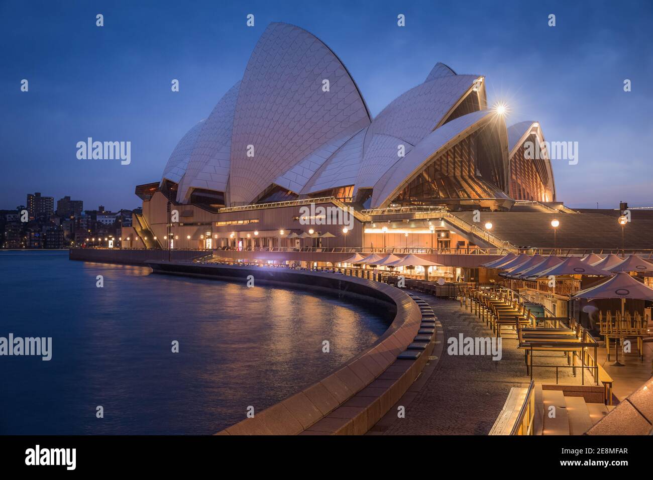 Sydney, Australia - January 12 2018: A pre-dawn Summer twilight cityscape view of the iconic Sydney Opera House and an empty Opera Bar in NSW. Stock Photo