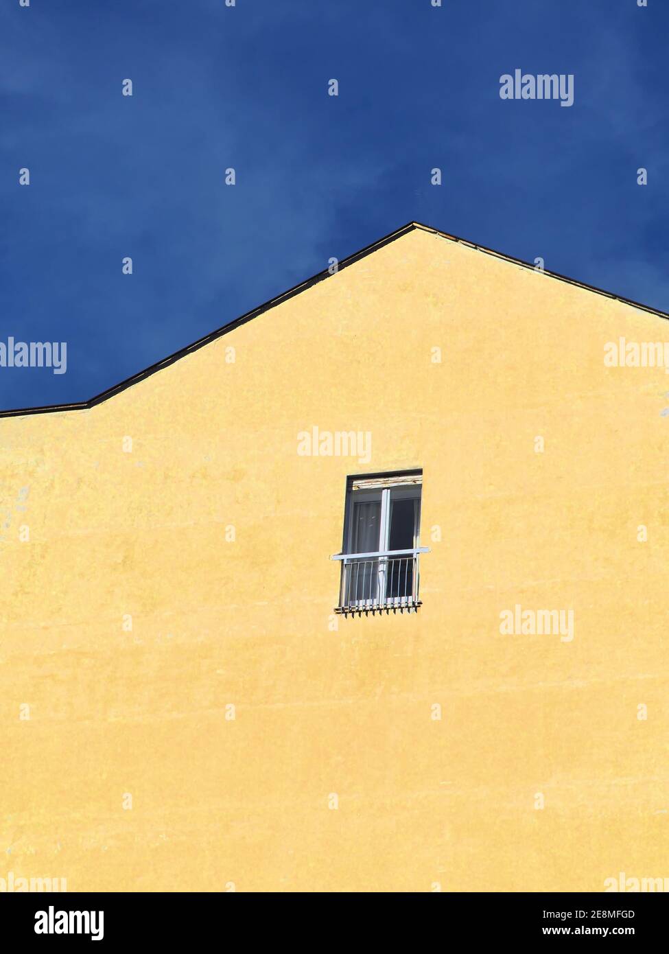 A single small window frame on the concrete wall - social isolation ...
