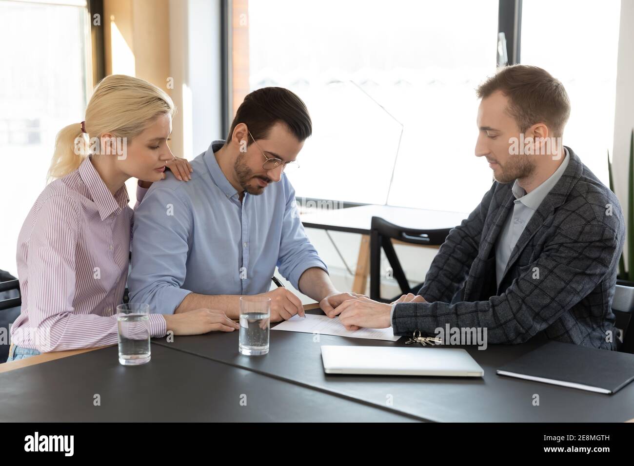 Couple meeting with consultant, legal expert, broker Stock Photo