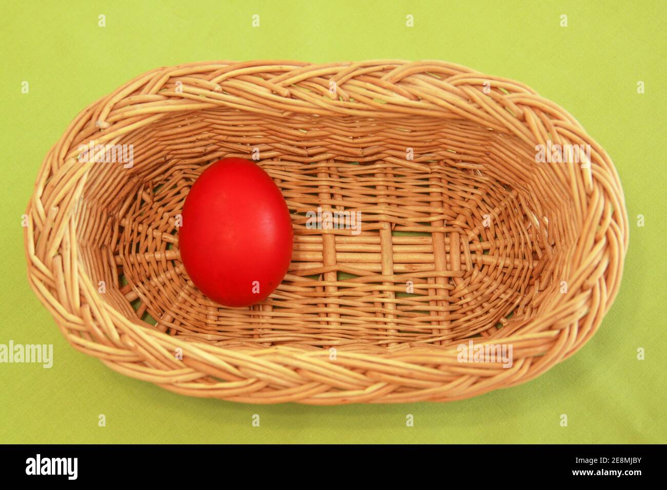 Colored painted Easter eggs in wooden basket decoration in preparation for holiday. Painting chicken or duck eggs is a Christian tradition to celebrat Stock Photo