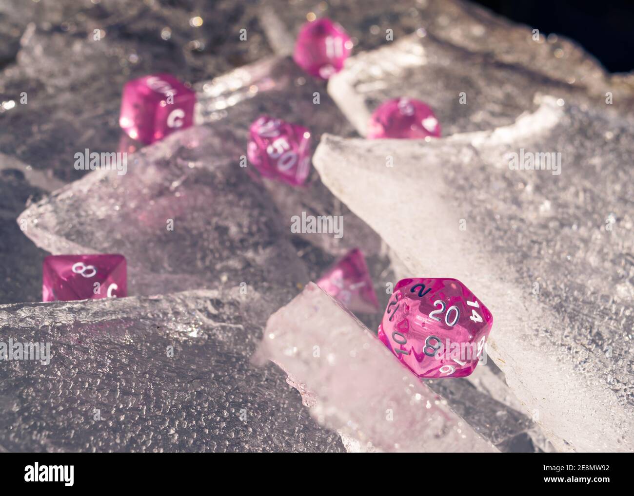 RPG dice on ice sheets in the sun. Focussed on the 20-sided sided die Stock Photo