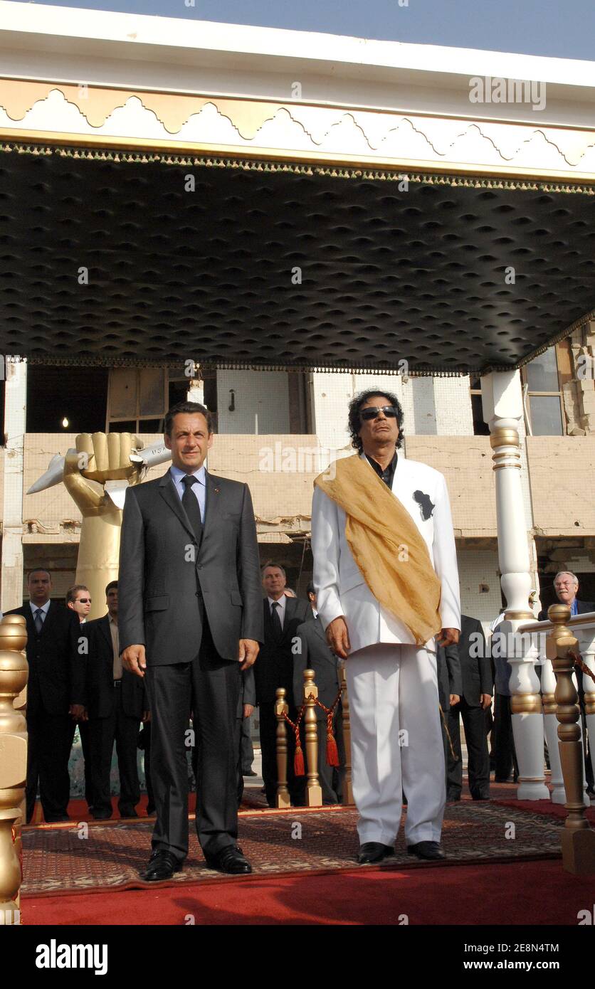 Libya's President Moammar Gadhafi and his counterpart from France Nicolas Sarkozy listen to national anthems at Bab Azizia Palace in Tripoli, Libya on July 25, 2007. France and Libya on Wednesday signed a memorandum of understanding to build a Libyan nuclear reactor for water desalination and clinched a raft of other deals. Photo by Christophe Guibbaud/ABACAPRESS.COM Stock Photo