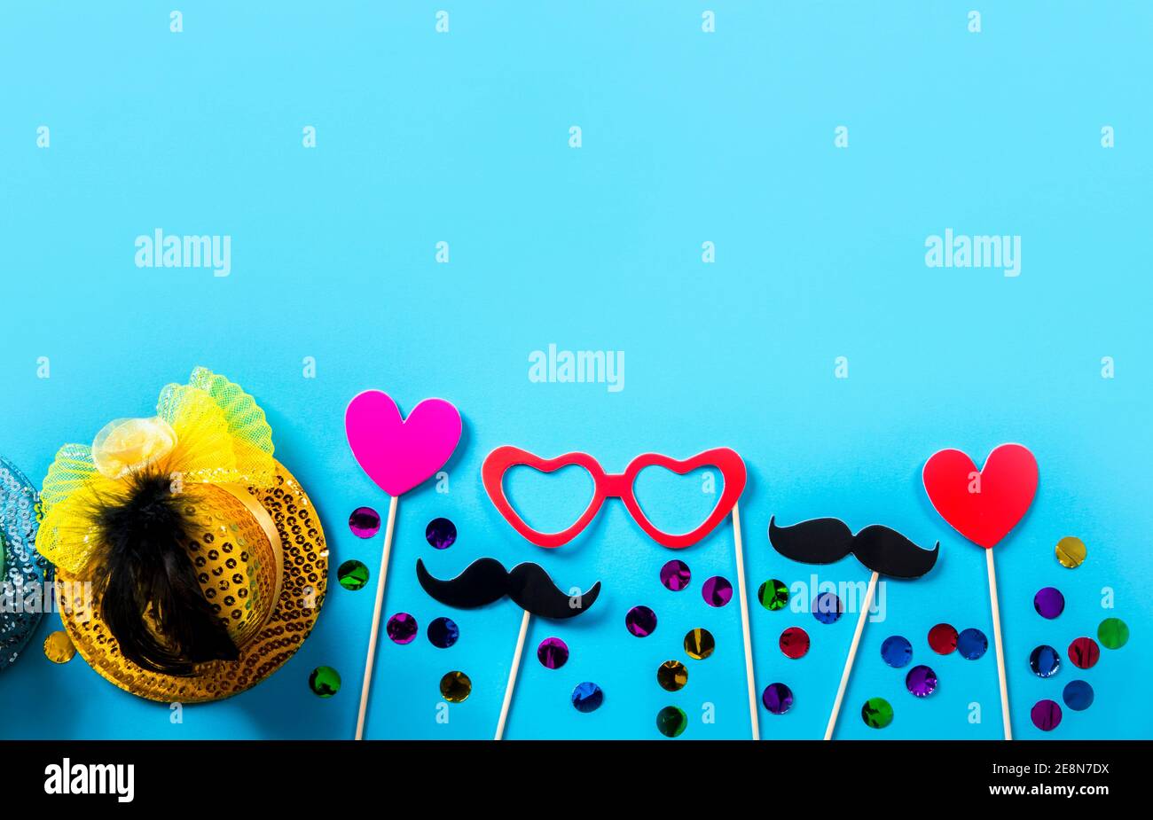 Flat lay view of festive party photo booth props. Lower border mustache, lips, glasses. Stock Photo
