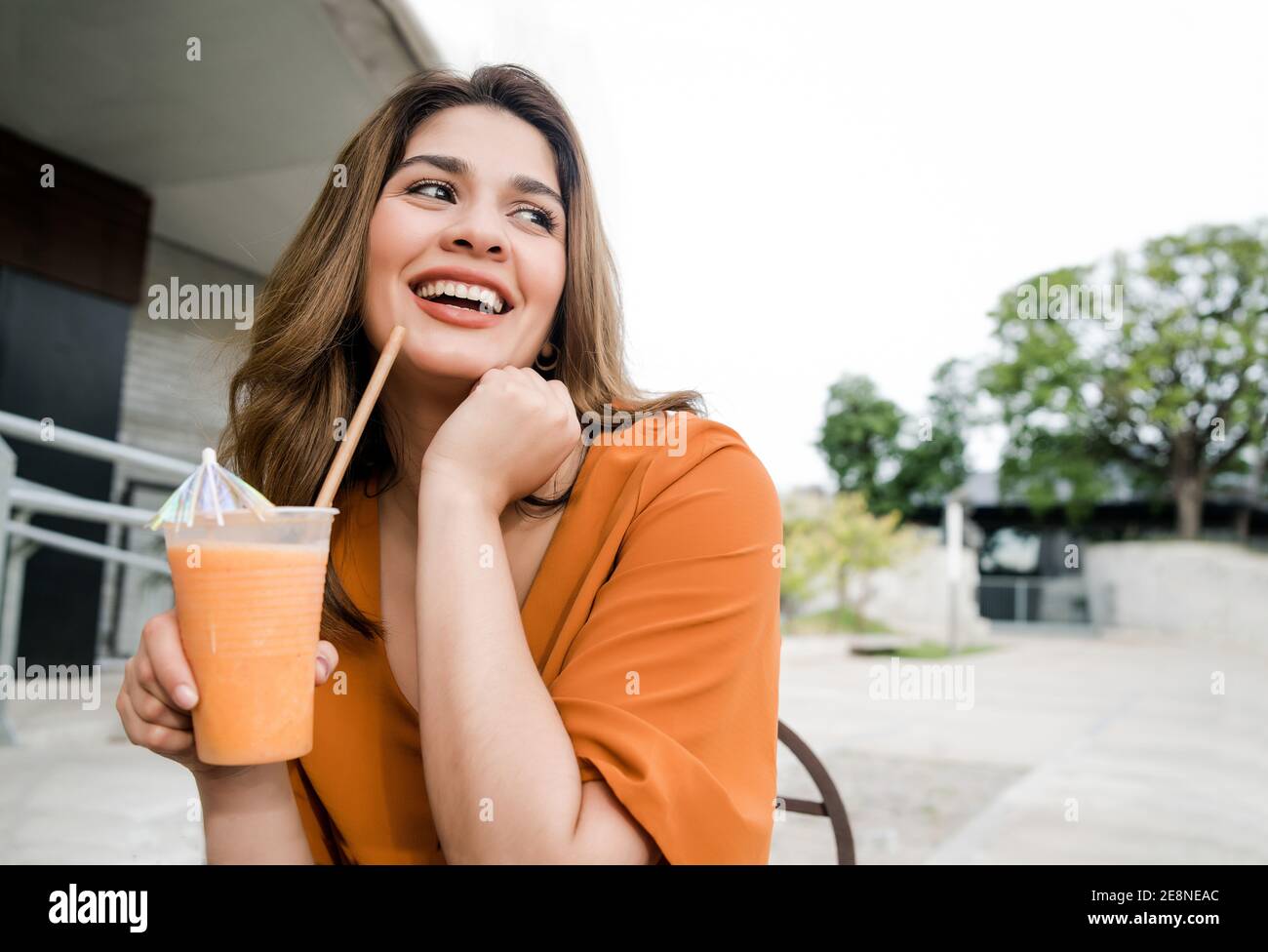 Woman drinking fresh fruit juice outdoors Stock Photo Alamy