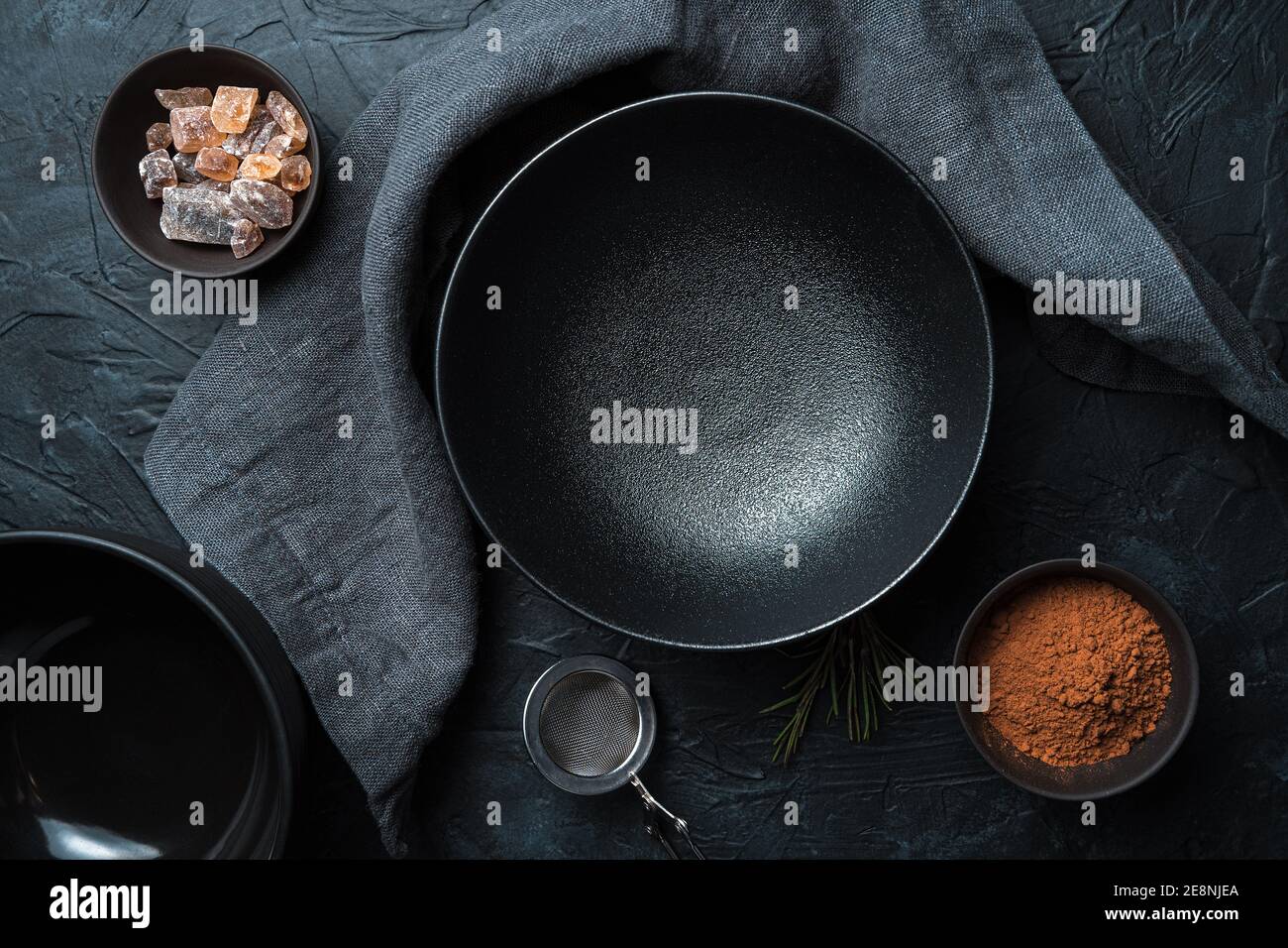 An empty black plate on a black background. Top view. Stock Photo
