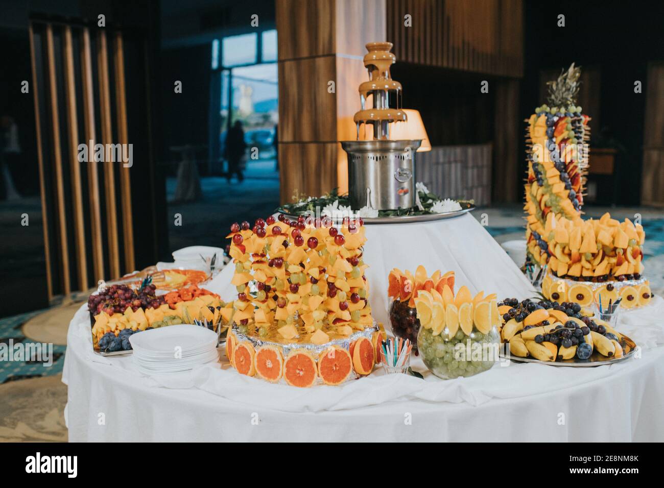 A beautiful buffet decoration with different fruits and with a chocolate  fountain Stock Photo - Alamy