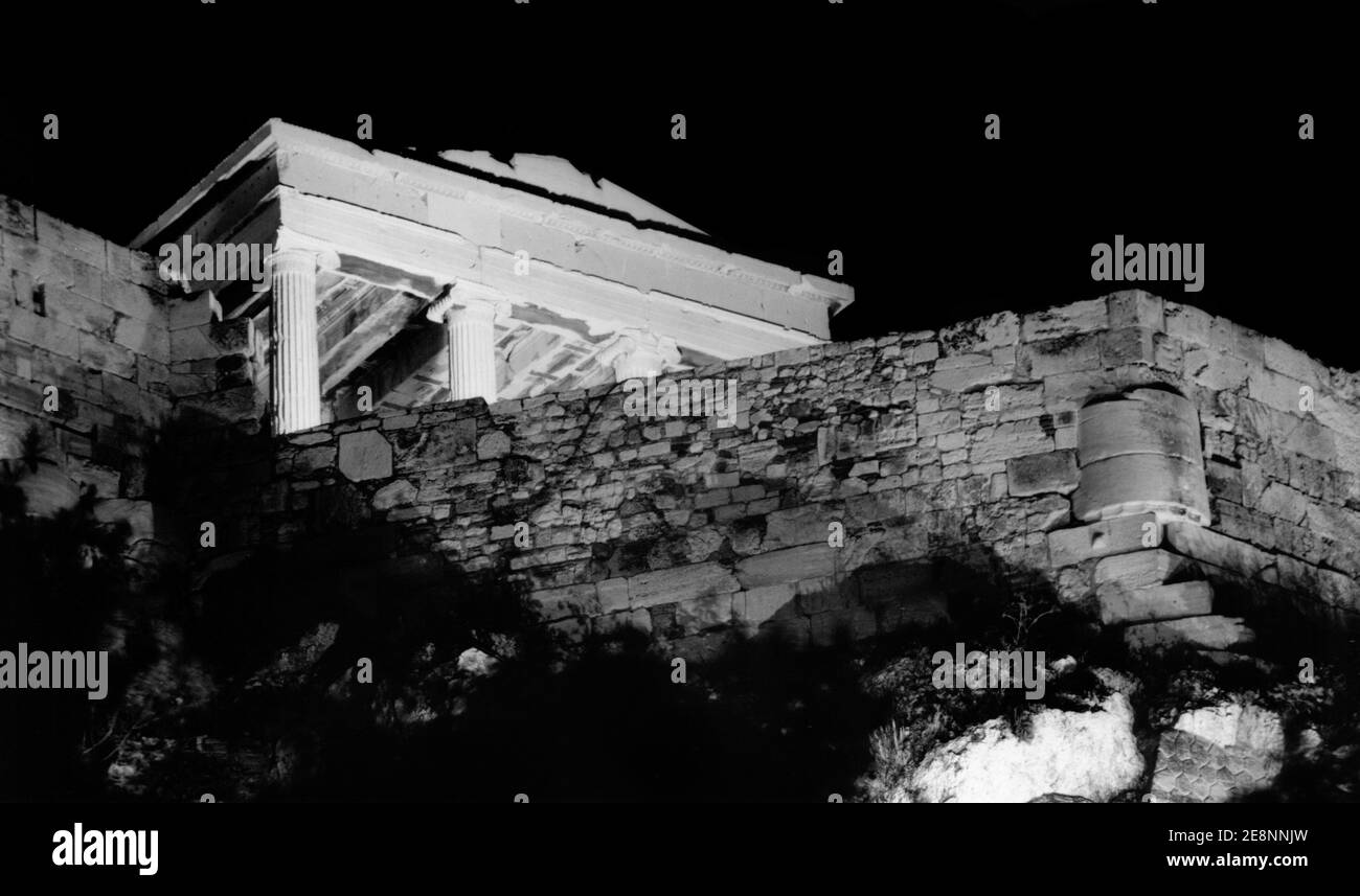 Part of the Erechtheion  and the walls of the Athens Acropolis, as seen illuminated at night Stock Photo