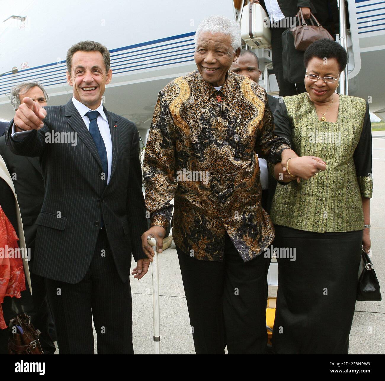 President Nicolas Sarkozy (l) welcomes former South African president Nelson Mandela and his wife upon their arrival at Orly airport, near Paris, France on September 3, 2007. The 89-year-old Nobel Peace Prize winner Mandela spent 27 years in prison before being freed in 1990, going on to become South Africa's first black leader in 1994 after the fall of apartheid. He received last week a hero's welcome in London, where a statue of him was unveiled opposite the Houses of Parliament. Photo by Thomas Coex/Pool/ABACAPRESS.COM Stock Photo