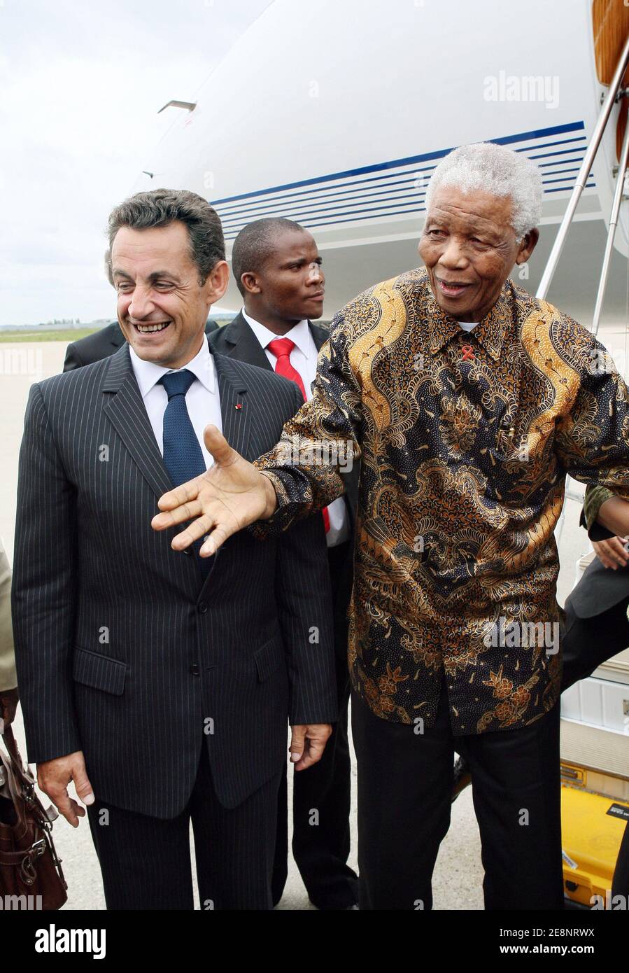 President Nicolas Sarkozy (l) welcomes former South African president Nelson Mandela and his wife upon their arrival at Orly airport, near Paris, France on September 3, 2007. The 89-year-old Nobel Peace Prize winner Mandela spent 27 years in prison before being freed in 1990, going on to become South Africa's first black leader in 1994 after the fall of apartheid. He received last week a hero's welcome in London, where a statue of him was unveiled opposite the Houses of Parliament. Photo by Thomas Coex/Pool/ABACAPRESS.COM Stock Photo