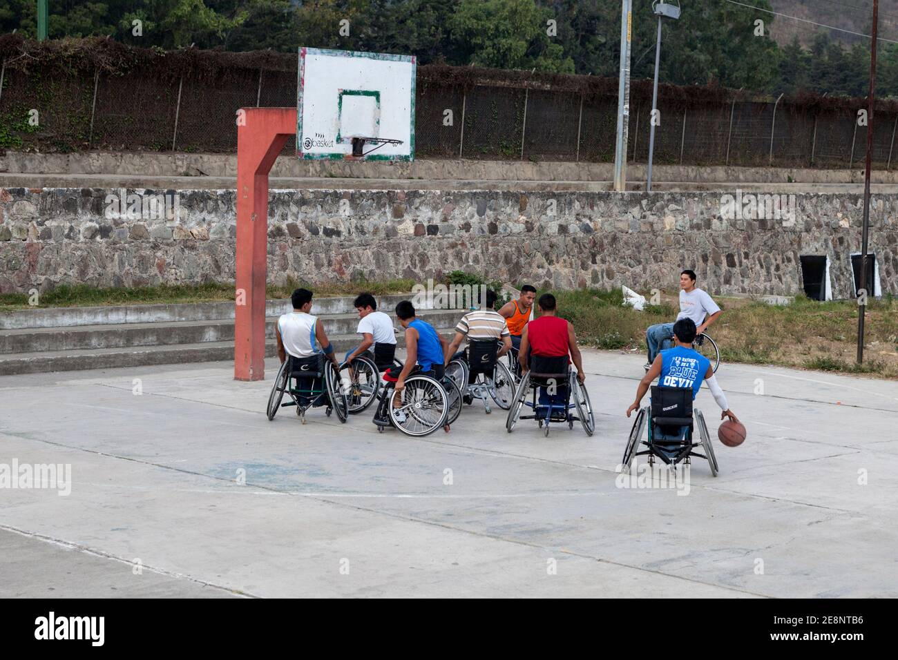 Antigua, Guatemala.  Disabled Young Men in Wheel Chairs Playing Basketball. Stock Photo