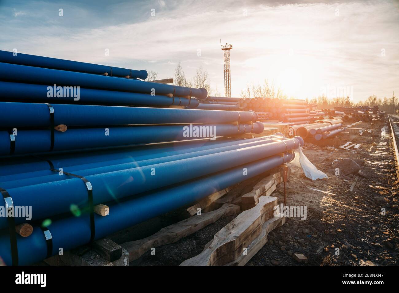 Stack of cast pipes for sewerage ready for transportation and distribution. Stock Photo