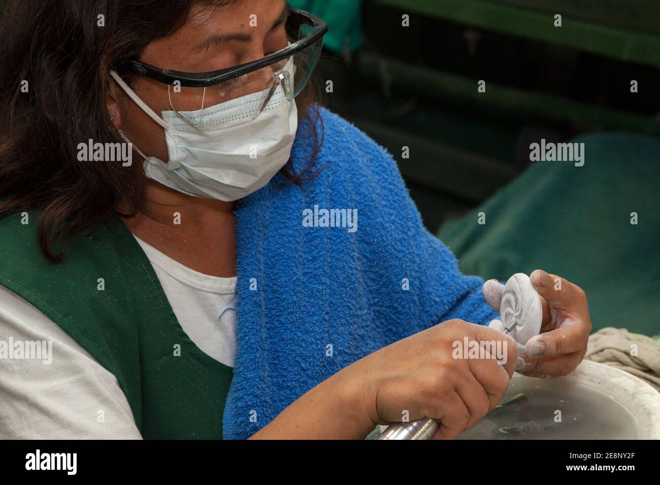 Antigua, Guatemala. Jade Factory Woman Carving a Design into