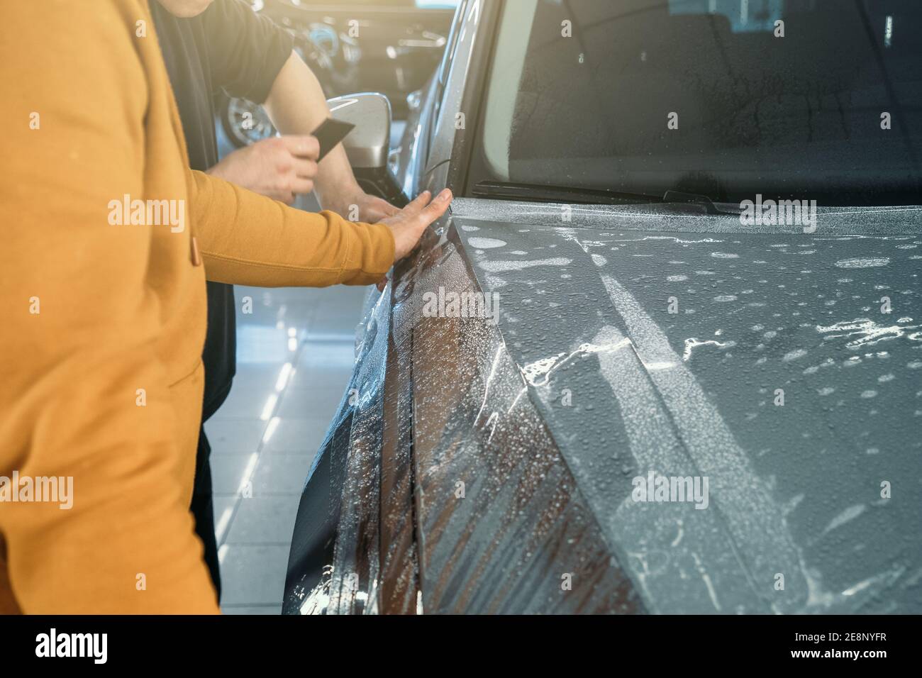 Installing PPF or Paint Protection Film on car as protective polymer