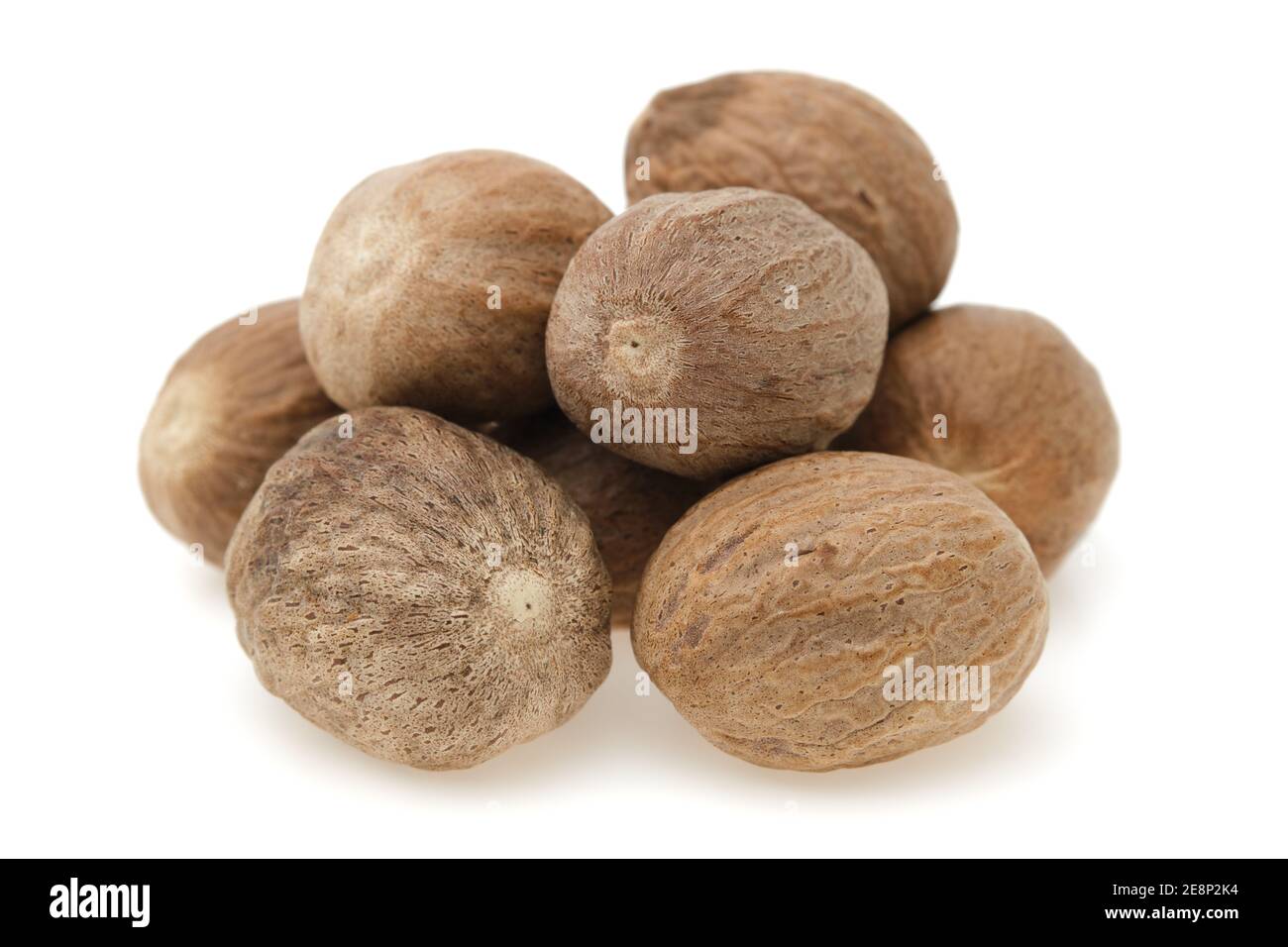 Nutmeg closeup on white background. Stock Photo