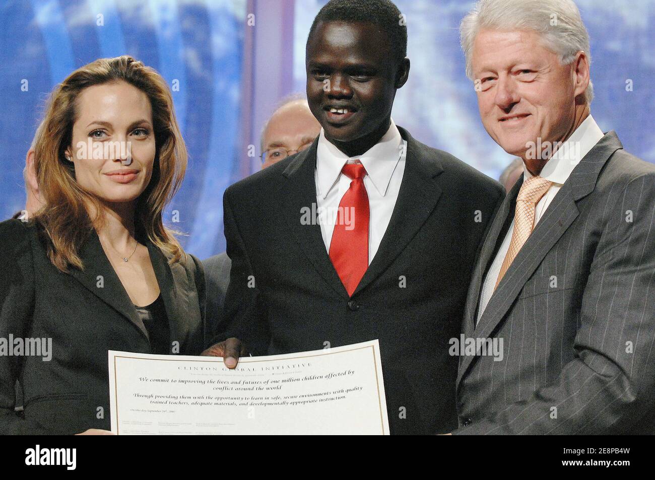 L-R) Angelina Jolie, Valentino Achak Deng and former US President Bill  Clinton on stage during a press conference on global education during the  Clinton Global Initiative annual meeting held at the the