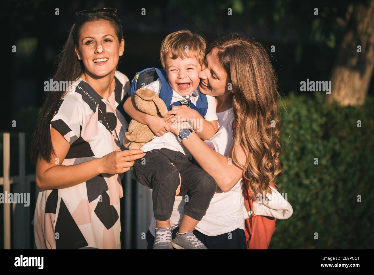 Mom and aunt holding a cute, little boy. Family love Stock Photo