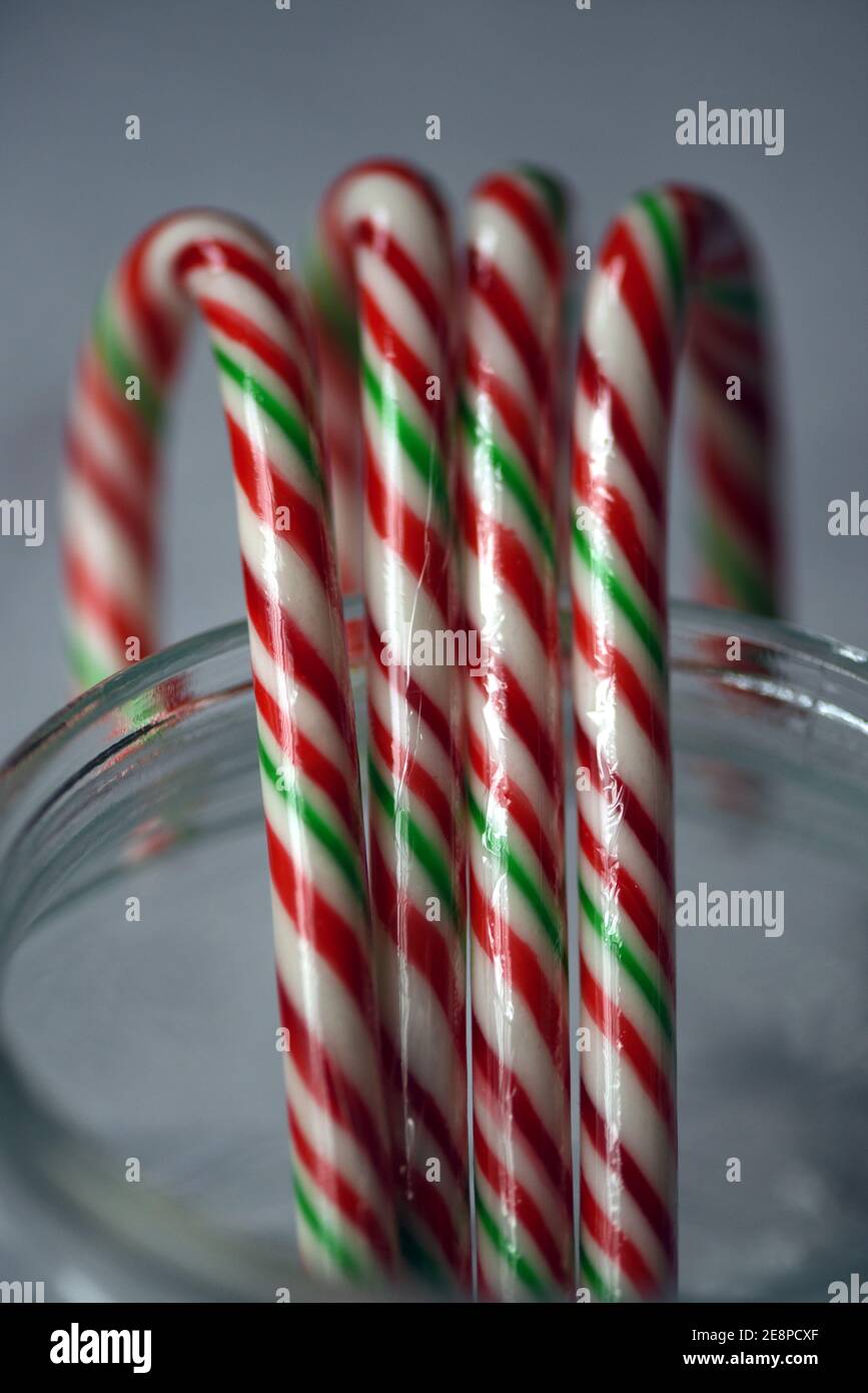 Christmas sweets, plastic wrapped candy canes in a clear glass jar Stock Photo