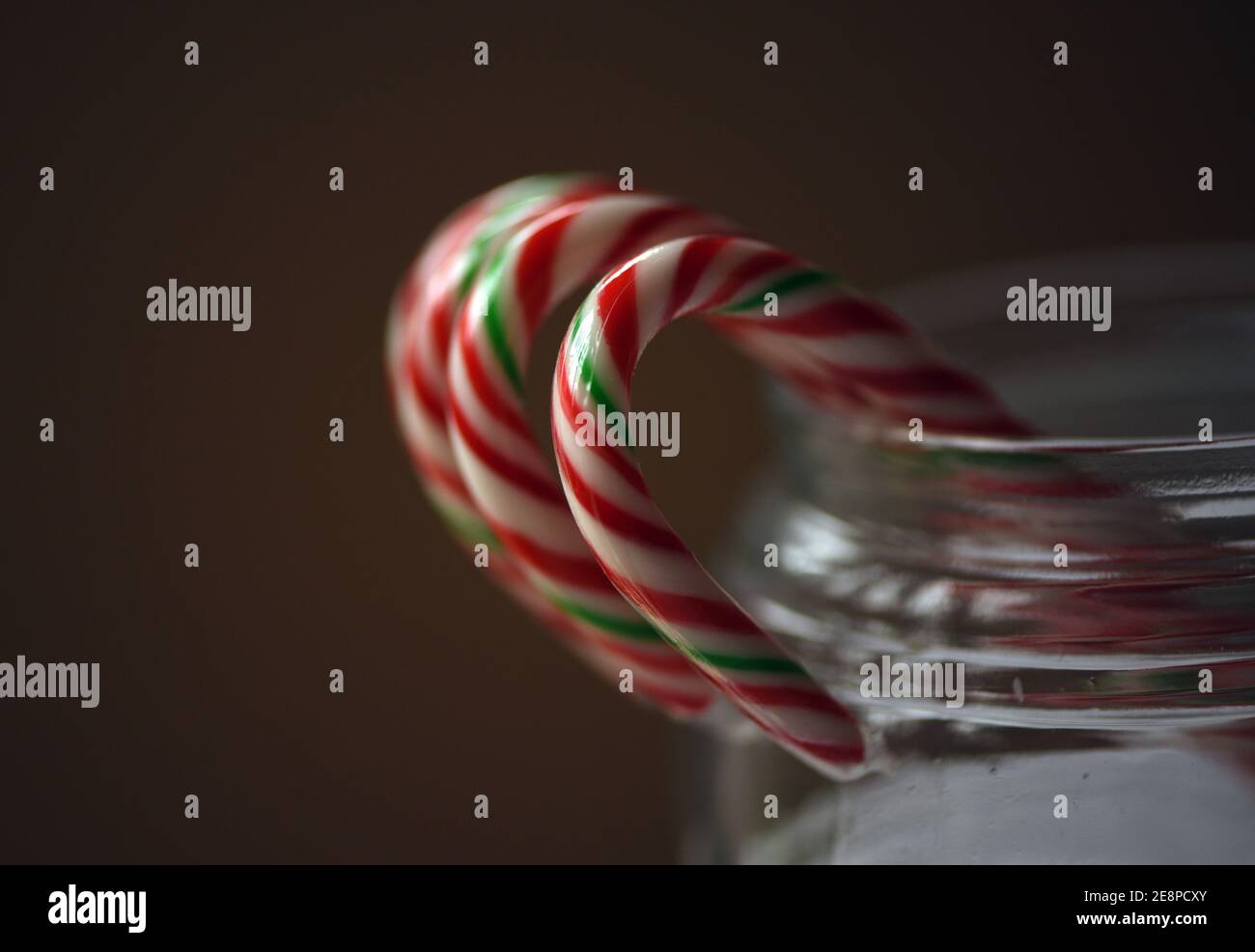 Christmas sweets, plastic wrapped candy canes in a clear glass jar Stock Photo