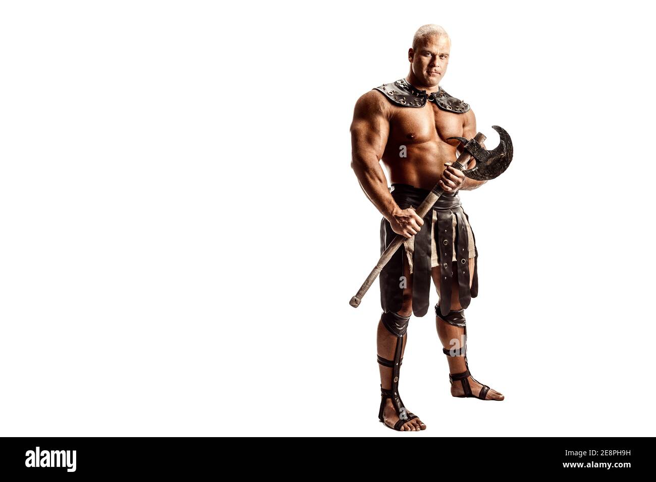 Studio shot of muscular ancient warrior man posing with axe. Isolated on white. Copy space Stock Photo