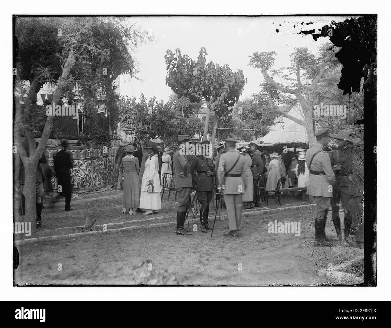 Military officials amd women outdoors near tent, possibly at fete for Y.W.C.A. Stock Photo