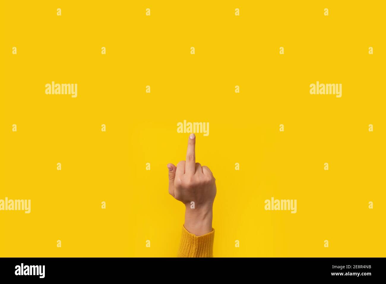 Hand gesture, fuck you symbol, middle finger sign over yellow