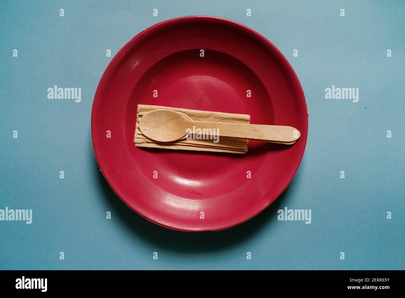 plastic plate with wooden utensil Stock Photo Alamy