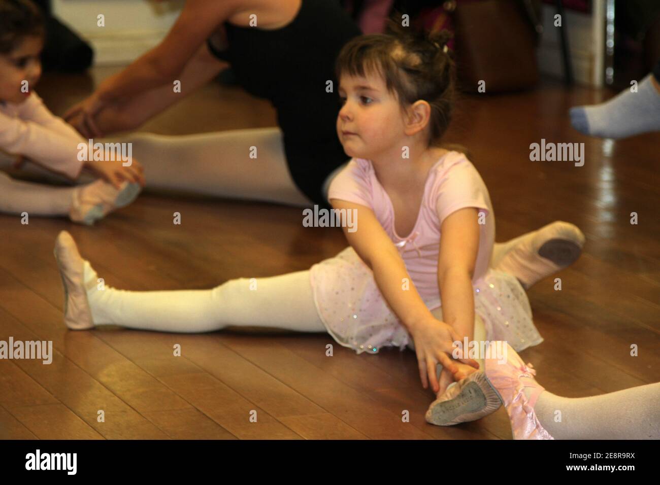 Girl practising ballet movements in class Stock Photo
