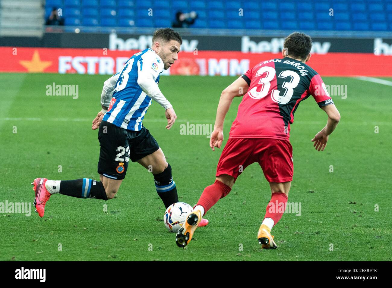 Cornella, Spain. 31st Jan, 2021. Espanyol's Adrian Embarba (L) vies with Vallecano's Fran Garcia during a Spanish second division league match between RCD Espanyol and Rayo Vallecano in Cornella, Spain, on Jan. 31, 2021. Credit: Joan Gosa/Xinhua/Alamy Live News Stock Photo